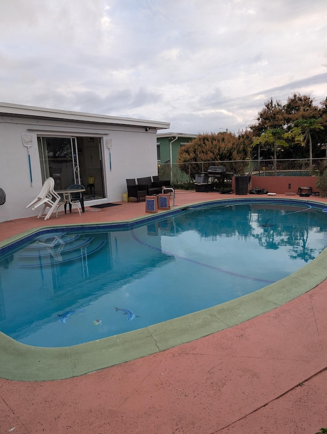 view of swimming pool with a patio