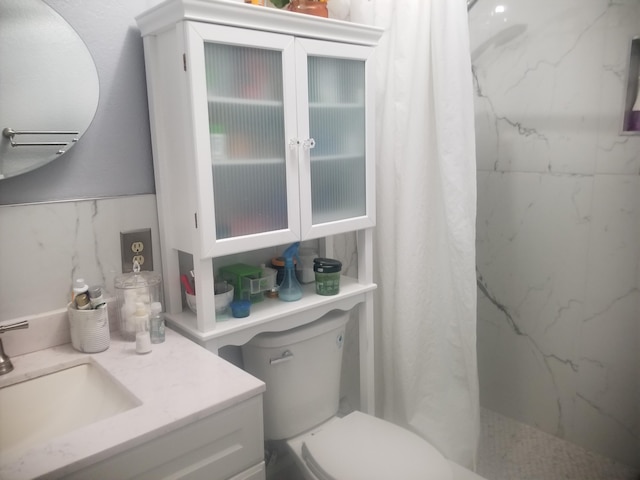 bathroom featuring vanity, toilet, and a shower with shower curtain