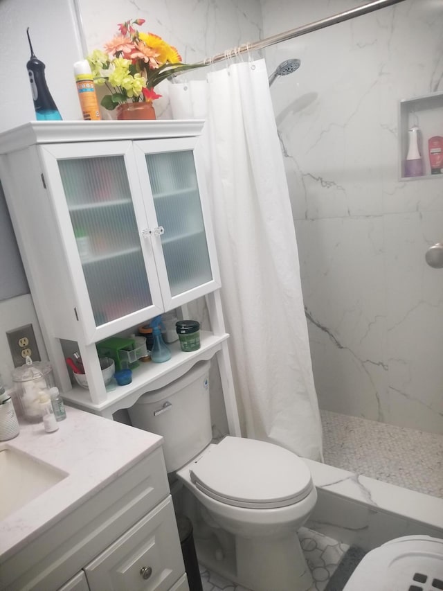 bathroom with vanity, toilet, and walk in shower