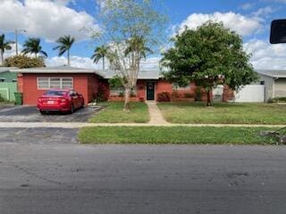 single story home with a front yard