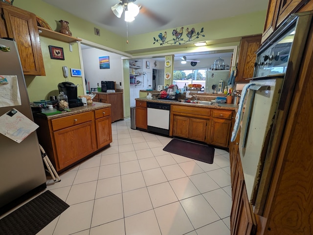 kitchen featuring ceiling fan, sink, dishwasher, and light tile patterned flooring