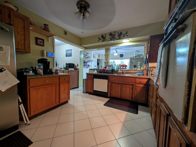 kitchen with stainless steel appliances, light tile patterned floors, and ceiling fan