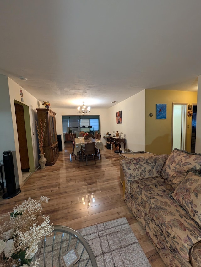 living room with light hardwood / wood-style floors and a chandelier