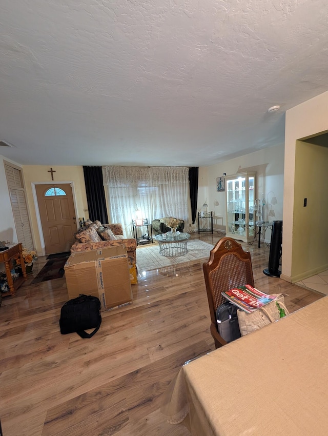 living room with plenty of natural light, hardwood / wood-style floors, and a textured ceiling