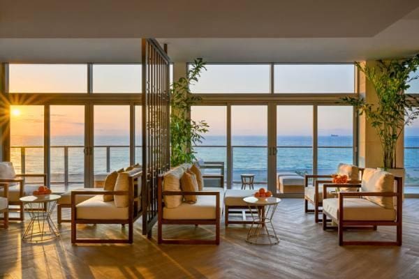 sunroom / solarium with a water view and a healthy amount of sunlight