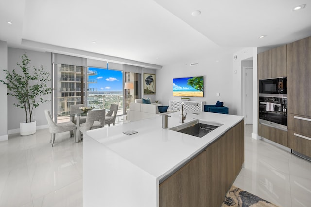 3100 N Ocean Dr Unit H-1508, Singer Island, FL 33404 - kitchen with stainless steel oven, modern cabinets, black microwave, a sink, and open floor plan