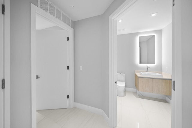 3100 N Ocean Dr Unit H-1508, Singer Island, FL 33404 - bathroom featuring vanity, toilet, and baseboards