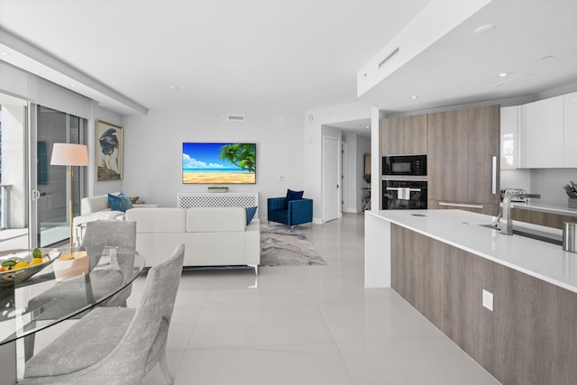 3100 N Ocean Dr Unit H-1508, Singer Island, FL 33404 - kitchen with modern cabinets, black appliances, open floor plan, light countertops, and a sink
