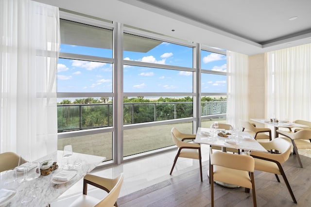 3100 N Ocean Dr Unit H-1508, Singer Island, FL 33404 - dining room with healthy amount of natural light, wood finished floors, and a water view