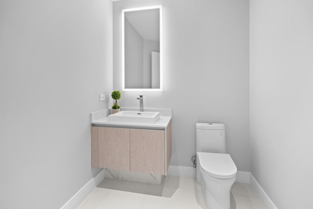 3100 N Ocean Dr Unit H-1508, Singer Island, FL 33404 - bathroom with toilet, vanity, baseboards, and tile patterned flooring