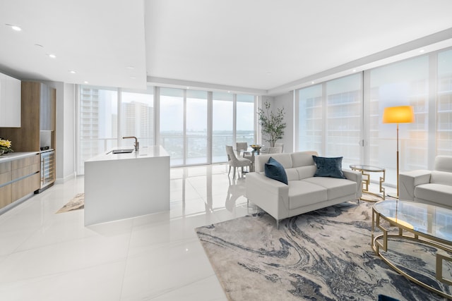 3100 N Ocean Dr Unit H-1508, Singer Island, FL 33404 - living area featuring expansive windows, light tile patterned flooring, beverage cooler, and recessed lighting