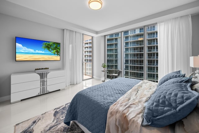 3100 N Ocean Dr Unit H-1508, Singer Island, FL 33404 - tiled bedroom featuring access to exterior and baseboards
