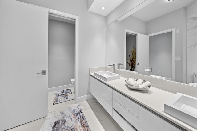 3100 N Ocean Dr Unit H-1508, Singer Island, FL 33404 - full bath featuring toilet, double vanity, marble look tile flooring, baseboards, and recessed lighting
