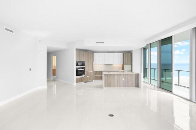 3100 N Ocean Dr Unit H-1508, Singer Island, FL 33404 - kitchen with modern cabinets, black microwave, wall oven, light countertops, and light tile patterned floors