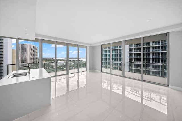 3100 N Ocean Dr Unit H-1508, Singer Island, FL 33404 - tiled empty room with a wall of windows and a sink