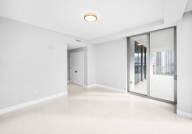 3100 N Ocean Dr Unit H-1508, Singer Island, FL 33404 - unfurnished room with baseboards and light tile patterned floors