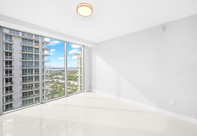3100 N Ocean Dr Unit H-1508, Singer Island, FL 33404 - tiled empty room with baseboards, a city view, and a smoke detector