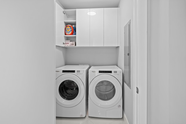 3100 N Ocean Dr Unit H-1508, Singer Island, FL 33404 - laundry room featuring washing machine and dryer, cabinet space, and light tile patterned flooring