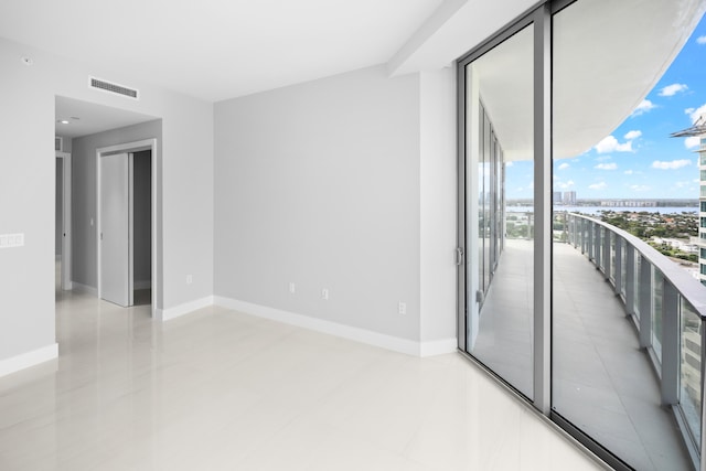 3100 N Ocean Dr Unit H-1508, Singer Island, FL 33404 - spare room with a city view, light tile patterned floors, baseboards, and expansive windows