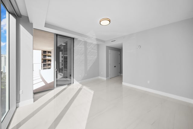 3100 N Ocean Dr Unit H-1508, Singer Island, FL 33404 - unfurnished room with floor to ceiling windows and baseboards