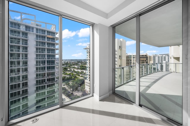 3100 N Ocean Dr Unit H-1508, Singer Island, FL 33404 - empty room featuring a city view, tile patterned floors, and baseboards