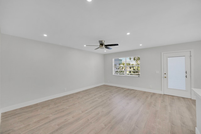 spare room featuring light wood-type flooring and ceiling fan