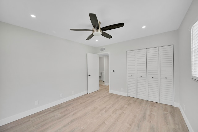 unfurnished bedroom featuring ceiling fan, light wood-type flooring, and a closet