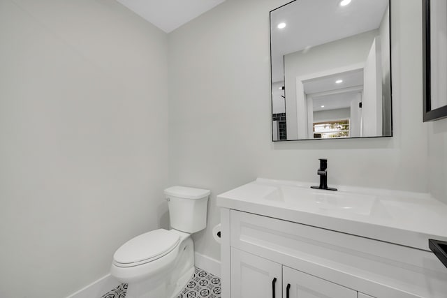 bathroom featuring vanity, toilet, and tile patterned floors