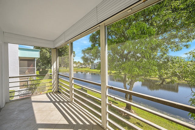 unfurnished sunroom featuring a water view