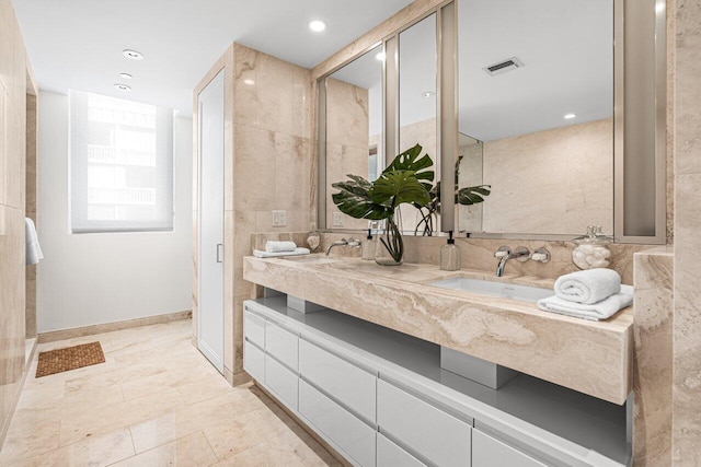 bathroom with vanity and tile walls