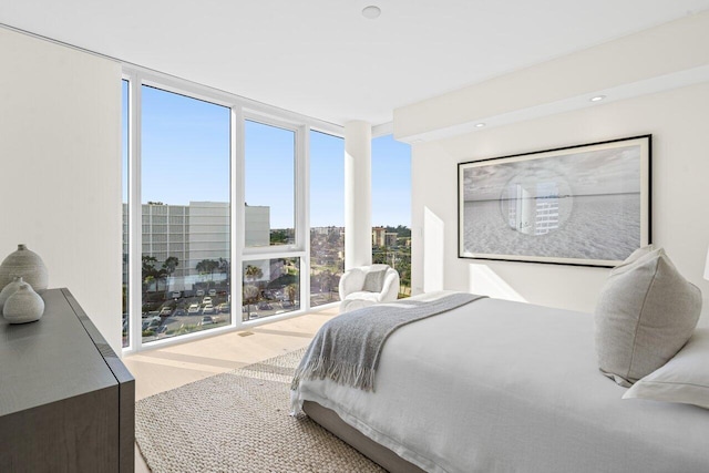 bedroom with a wall of windows and multiple windows