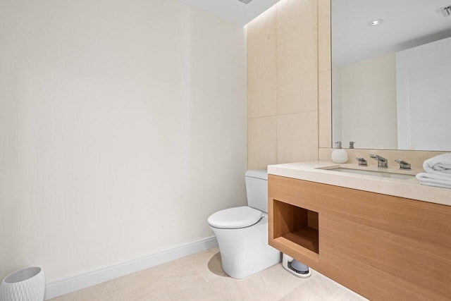 bathroom featuring vanity, toilet, and tile patterned flooring