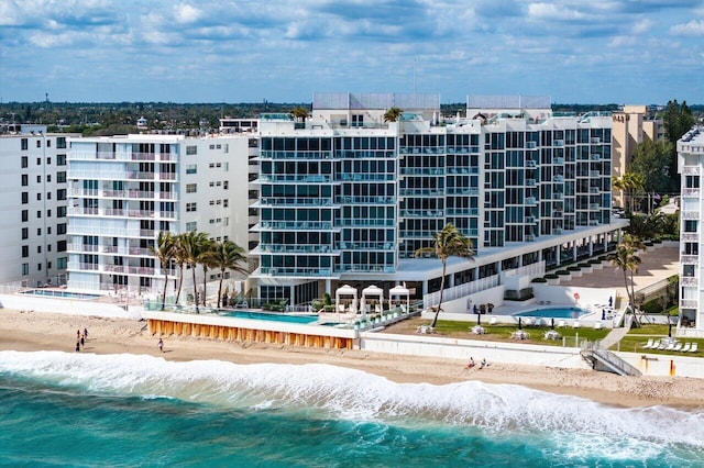 view of property featuring a water view and a view of the beach