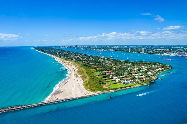 birds eye view of property with a water view and a beach view