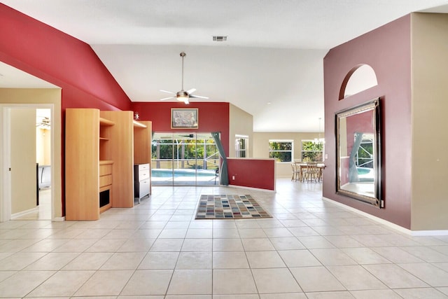 unfurnished living room with visible vents, high vaulted ceiling, light tile patterned floors, baseboards, and ceiling fan