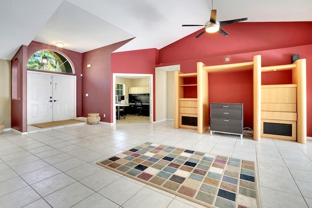 entrance foyer with lofted ceiling, light tile patterned flooring, baseboards, and ceiling fan