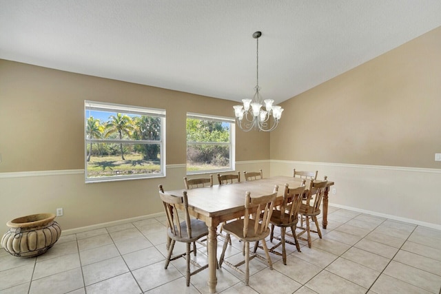 dining room with light tile patterned floors, baseboards, and an inviting chandelier