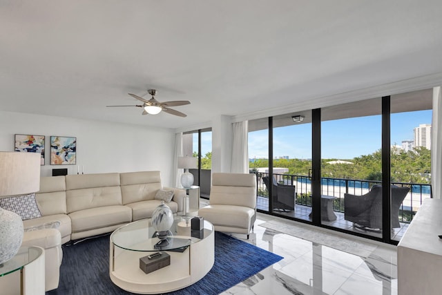 living room featuring ceiling fan and a wall of windows