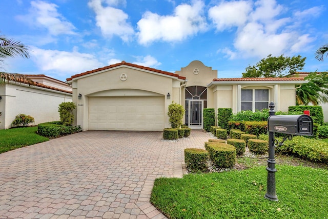 3660 Northwind Ct, Jupiter, FL 33477 - mediterranean / spanish-style house with stucco siding, decorative driveway, a garage, and a tiled roof