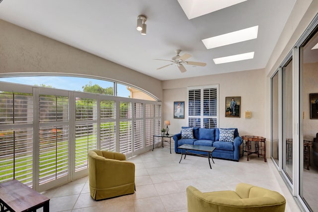 sunroom with a skylight and ceiling fan