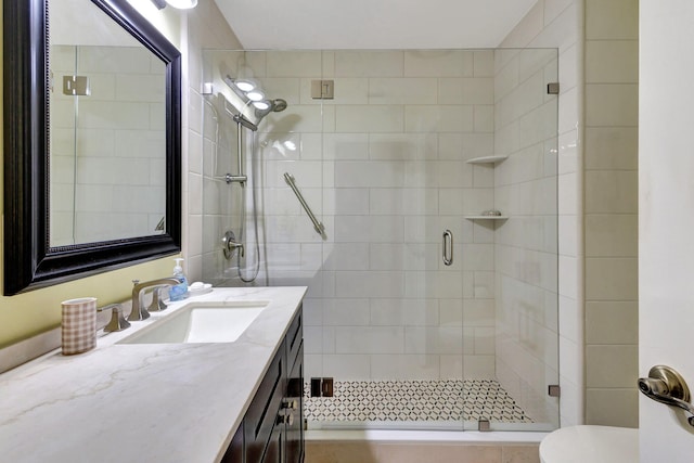 bathroom with vanity, toilet, and an enclosed shower