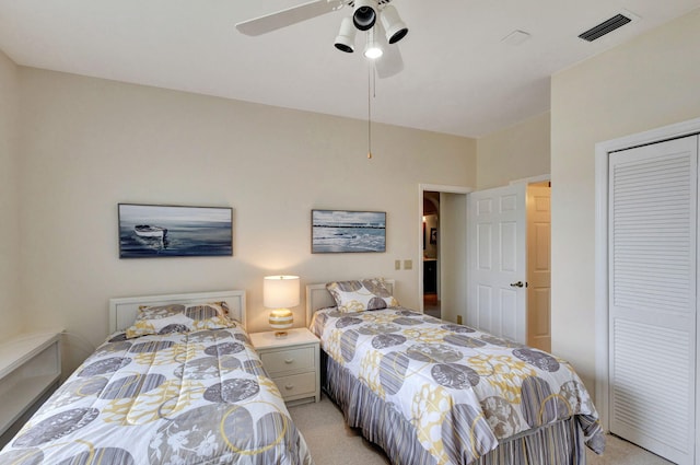 carpeted bedroom with a closet and ceiling fan