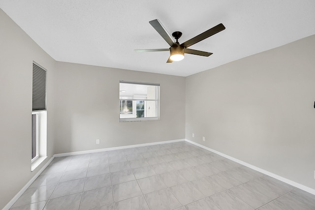 spare room featuring ceiling fan and a textured ceiling