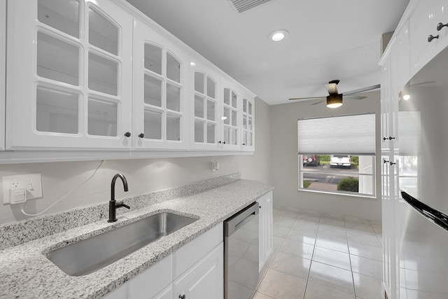 kitchen with light tile patterned flooring, sink, white cabinetry, stainless steel appliances, and ceiling fan