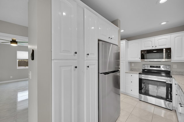 kitchen with light stone counters, ceiling fan, light tile patterned floors, white cabinetry, and stainless steel appliances