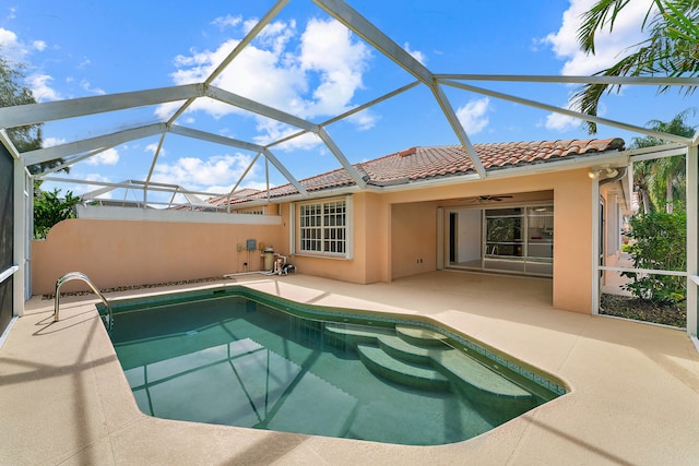 back of property featuring a patio area, ceiling fan, and a lanai