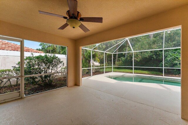 view of swimming pool featuring ceiling fan and a patio