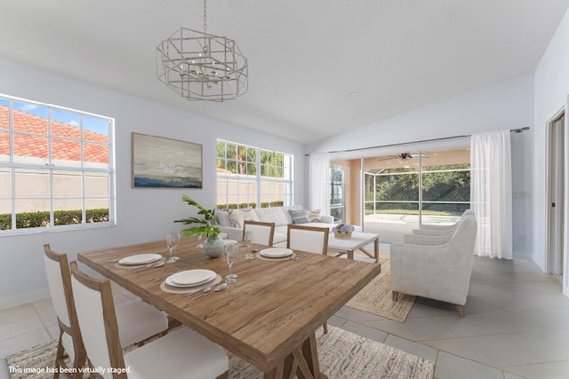 dining room with light tile patterned flooring, vaulted ceiling, and an inviting chandelier