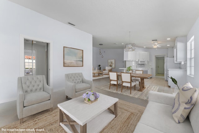 living room featuring ceiling fan, a healthy amount of sunlight, and light tile patterned floors