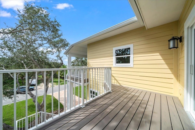 wooden terrace featuring a yard